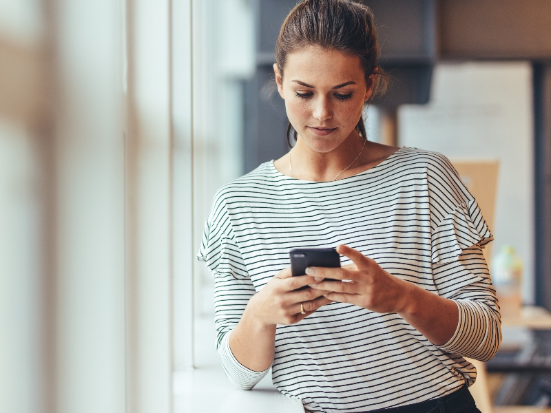 Woman approving invoices on mobile device